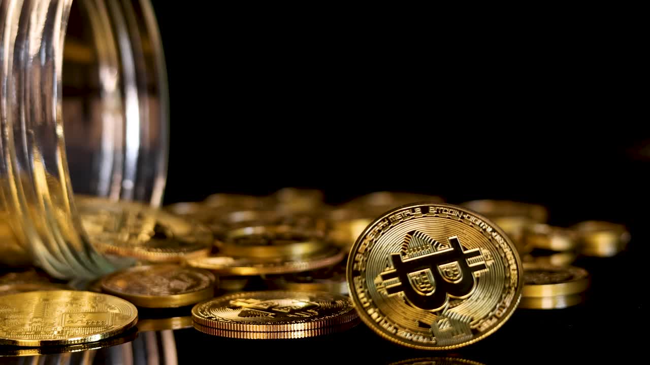 Gold digital token spins and settles among scattered coins from tipped transparent jar, dramatic lighting