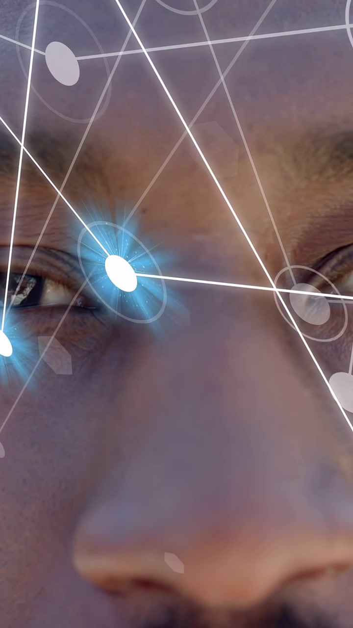 Vertical video: Man opening eyes slowly as biometrics overlay activating, blue node tracking eye