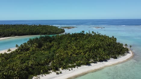 Remote-tropical-islands-in-lagoon-with-palm-trees-barrier-reef-and-ocean-aerial-shot