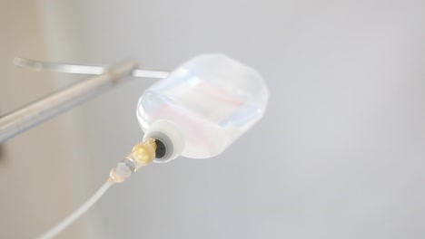 saline drop in a drip chamber being infused along with medicine, and nutrients into a circulatory system of a patient