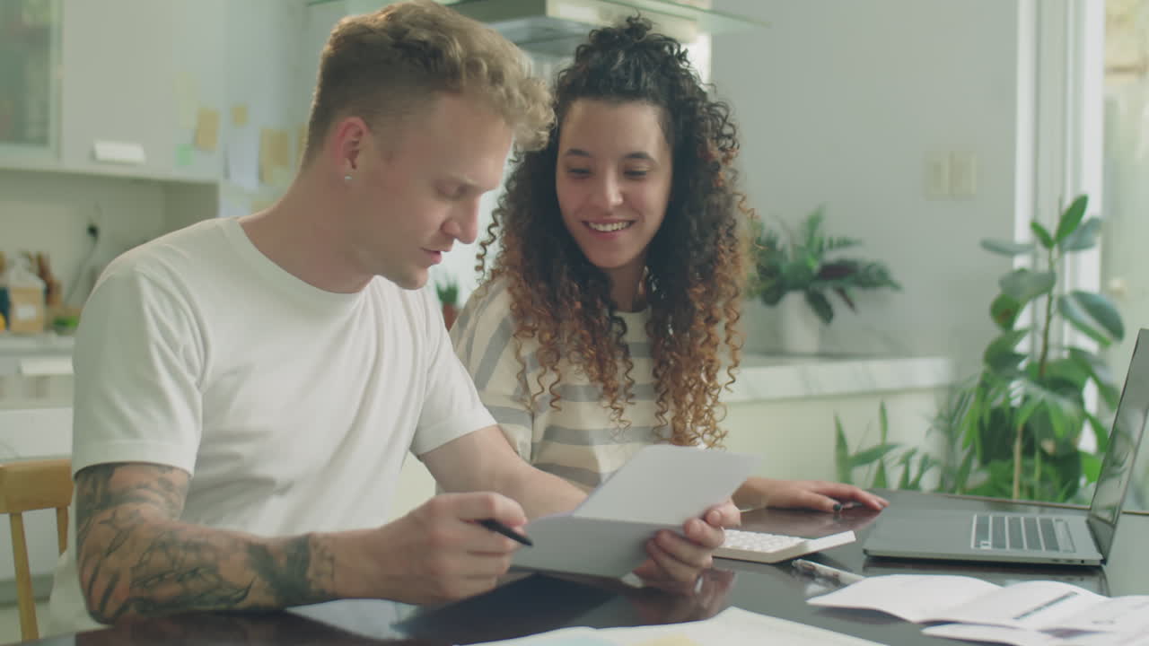 Couple Discussing Bills and Planning Personal Finance at Home