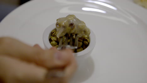 food in a bowl with a fork