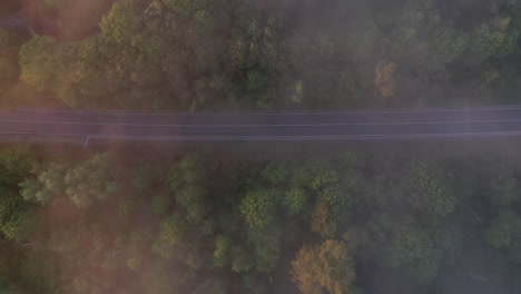 Drone-aerial-view-of-road-during-foggy-morning