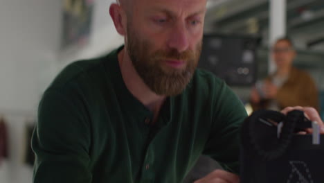 man looking at clothes on a film set