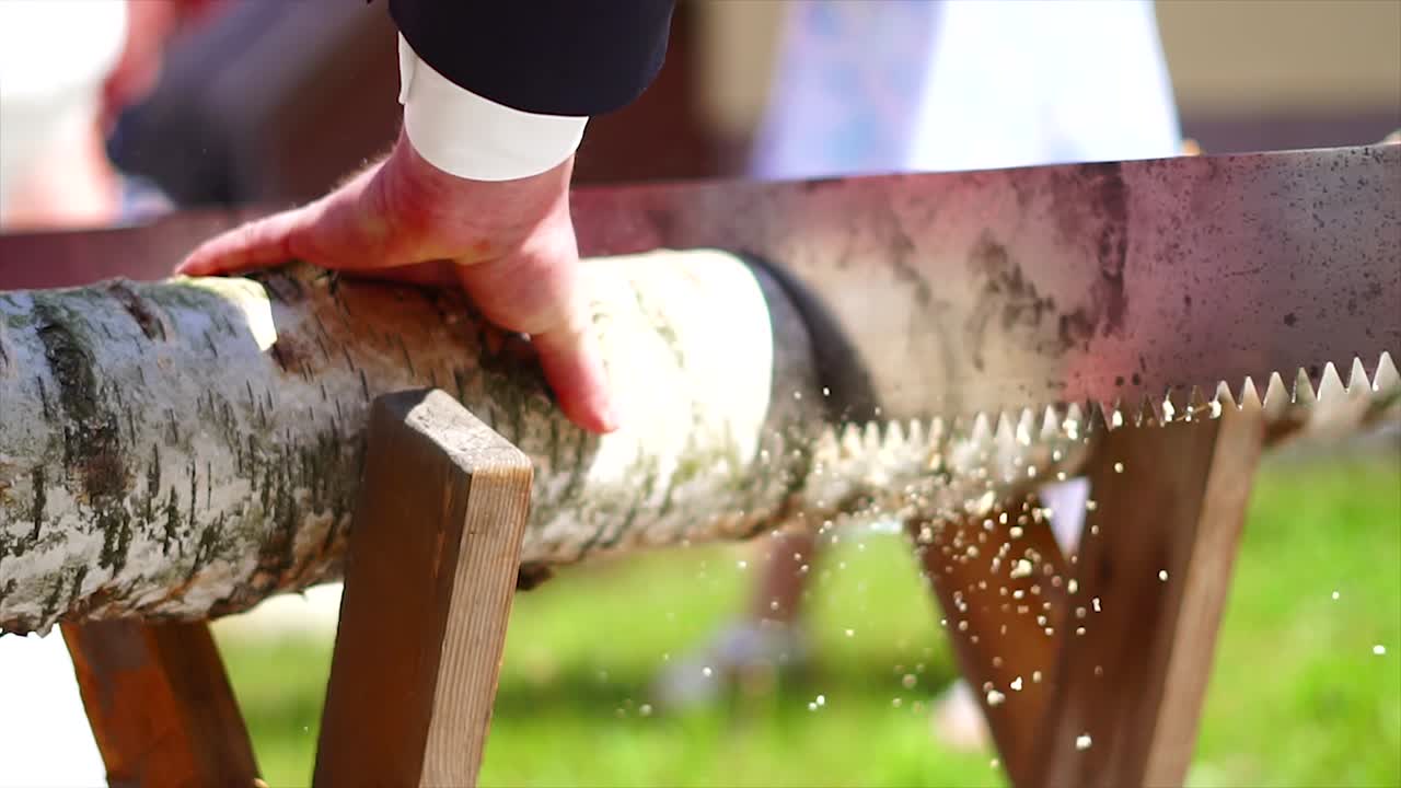 Married couple sawing wood on their wedding