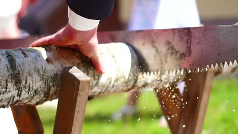 married couple sawing wood on their wedding