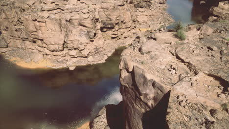Desert canyons tranquil waters are bordered by natural rock formations