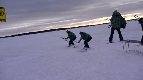 winter snowkiting on the rail with freeze frame effect , kiter frozen in time shot in the suny windy winter day evening.