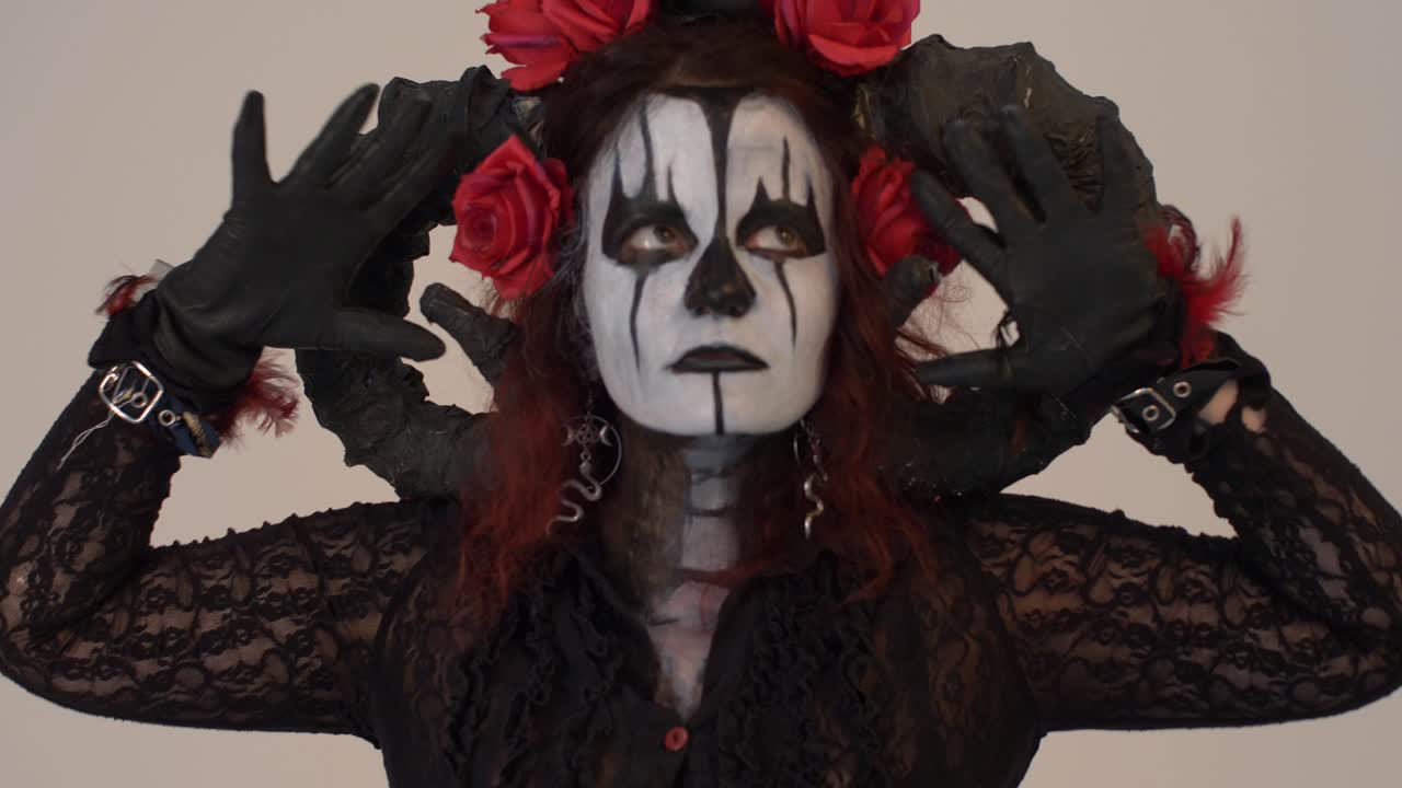 Catrina Cosplay girl moving her hands infront of her face with a Light background, Medium close up