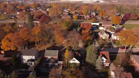 residential area with colorful autumn landscapes during daytime in trenton, michigan usa - aerial sideways