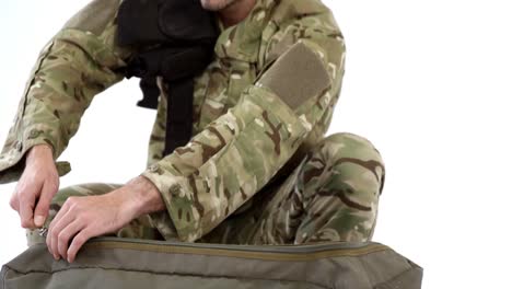 Soldier-packing-bag-on-white-background