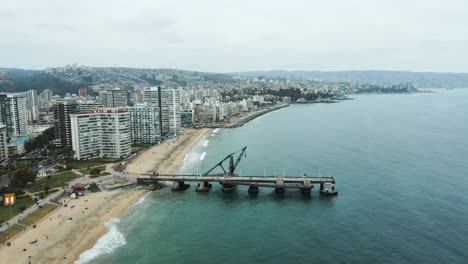 Aerial-view-of-Vergara-pier-in-Viña-del-Mar-city-revealing-the-coast-of-Valparaiso-bay