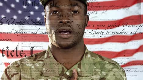 African-American-soldier-hand-on-heart-with-US-flag-waving-and-constitution-foreground