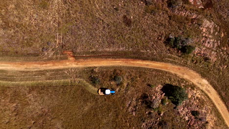 tractor with slasher mower cut veld grasses as part of farm upkeep. aerial