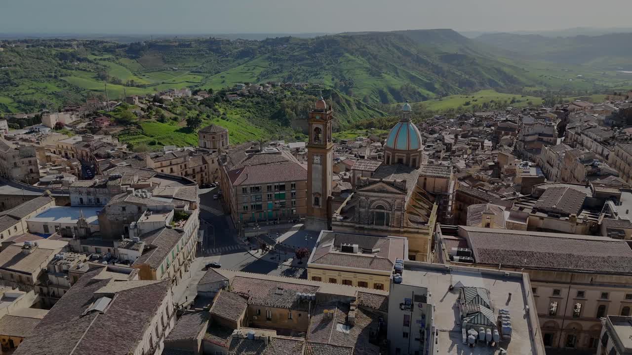 Flight around Caltagirone’s cathedral with the countryside hills in background during a spring day