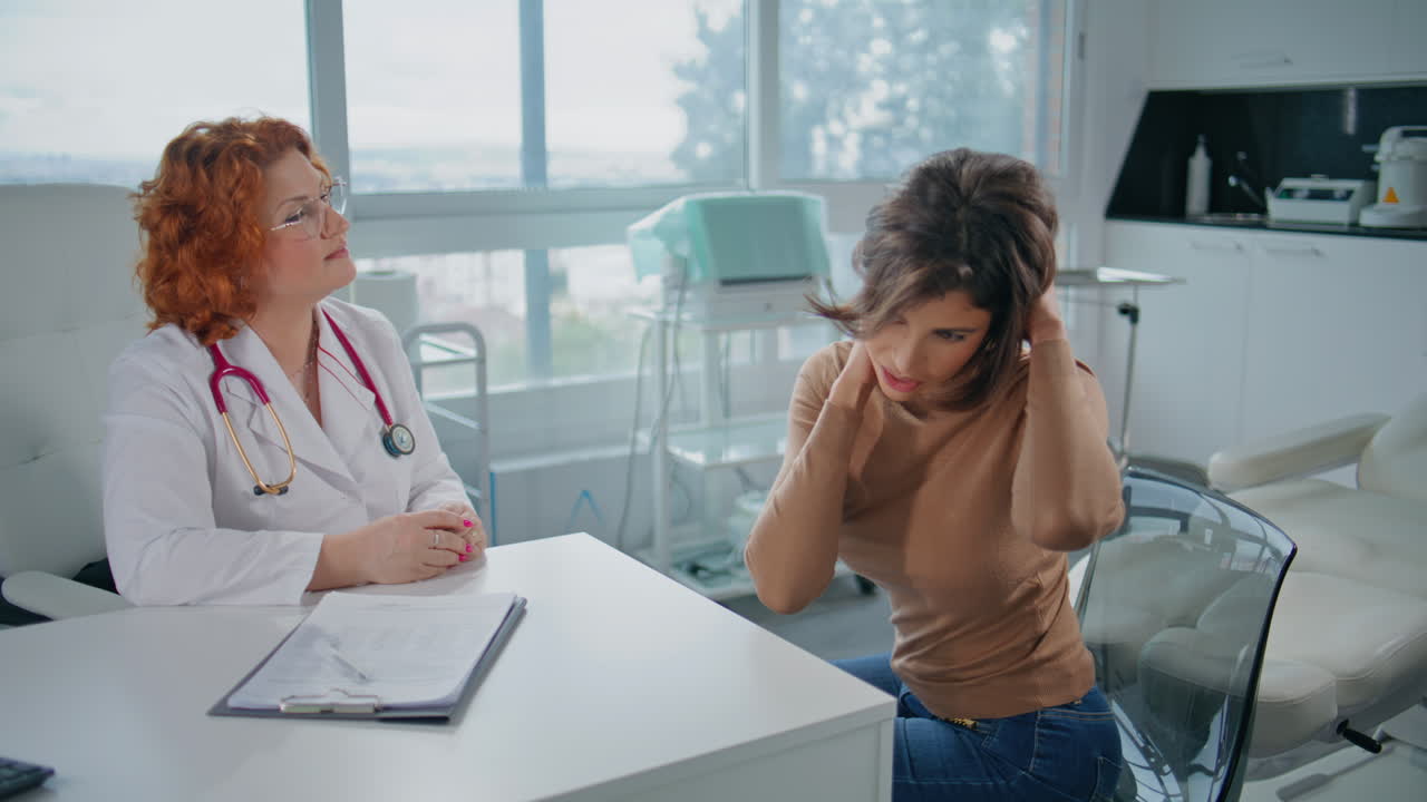 Patient explaining health problem to doctor in healthcare clinic closeup
