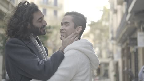 affectionate gay couple hugging on a city street