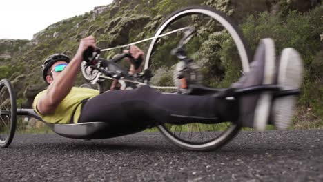 disabled man riding a recumbent bicycle