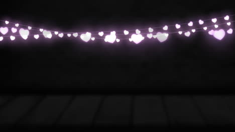 animation of purple heart shaped glowing fairy lights hanging against copy space on black background