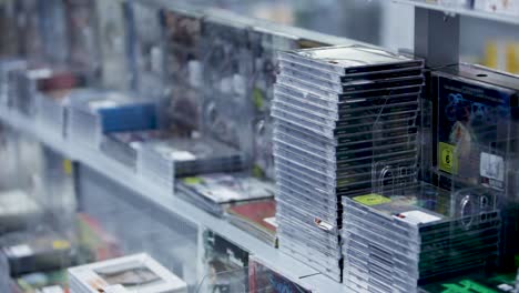 stacked cds on store shelves display various albums in clear cases, ready for purchase