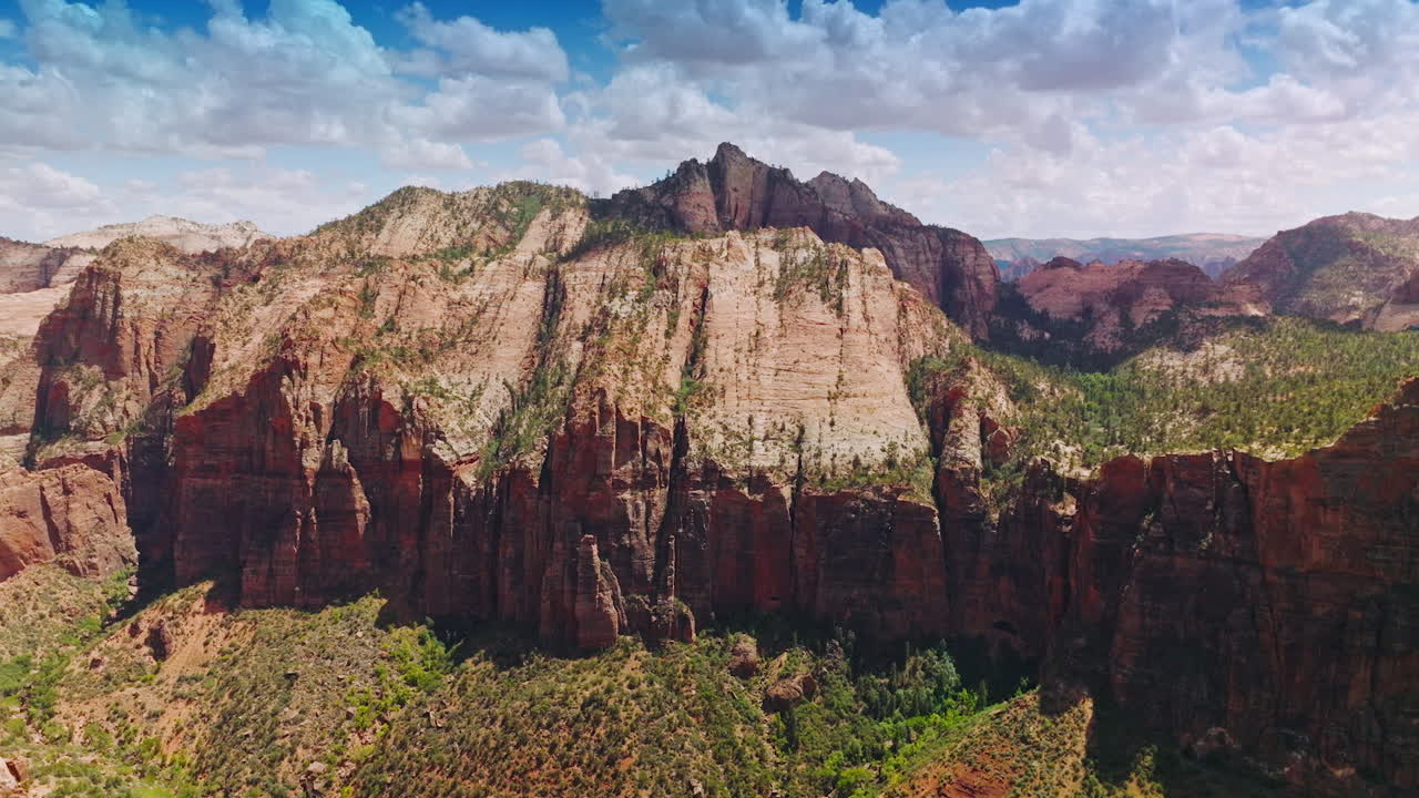 Tremendous rocks of Zion National Park on beautiful sunny day. Beautiful blue skies with lovely clouds at backdrop. Aerial view.