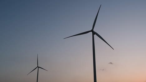 Wind-Turbines-Silhouette-against-the-Blue-sky-during-Sunset,-clean-alternative-energy-in-Thailand-and-mainland-Southeast-Asia