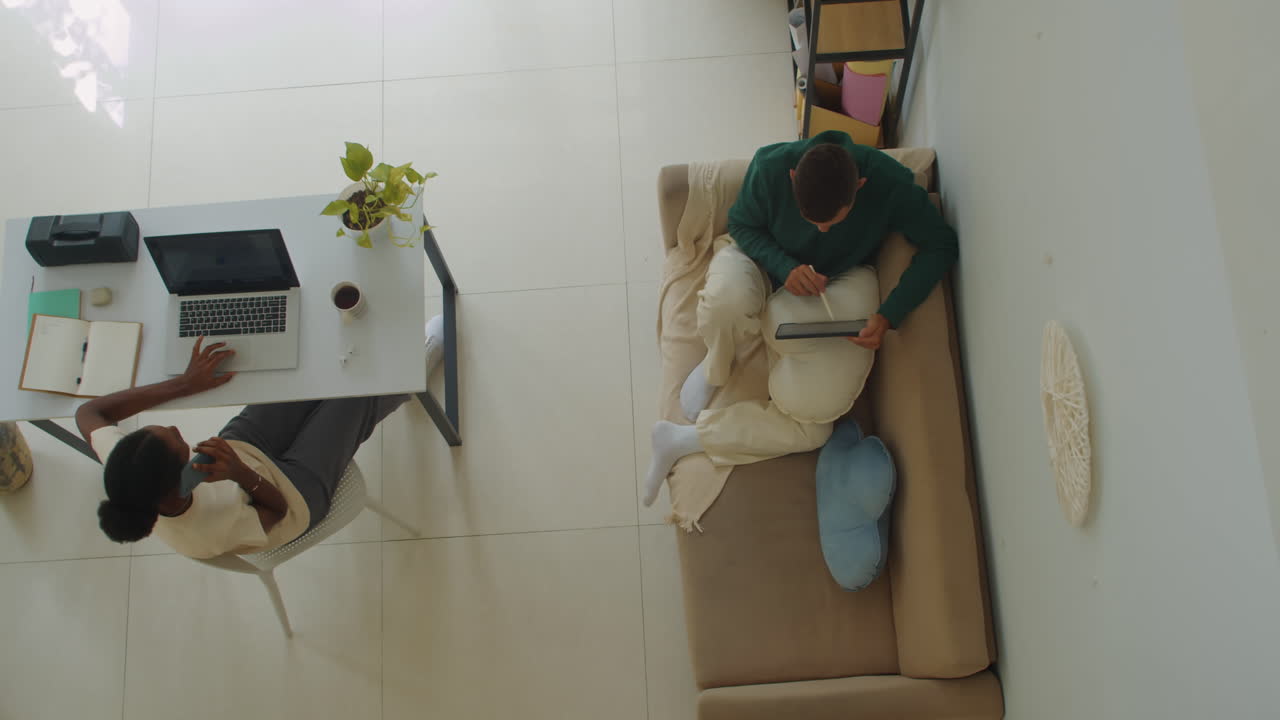 Couple of Freelancers Working at Home View from above