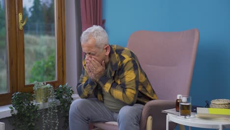 man covering mouth and nose while sneezing.