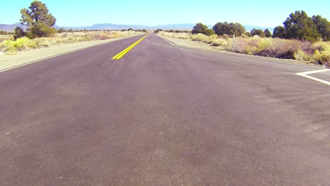 pov shot along a desert road driving fast