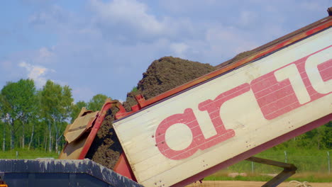 dumping cement into a concrete paving machine