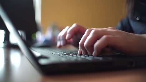 Woman-using-laptop-at-home-holding-mouse-clicking