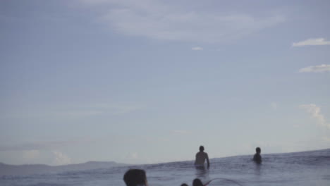 asian filipino surfer lying on his surfboard