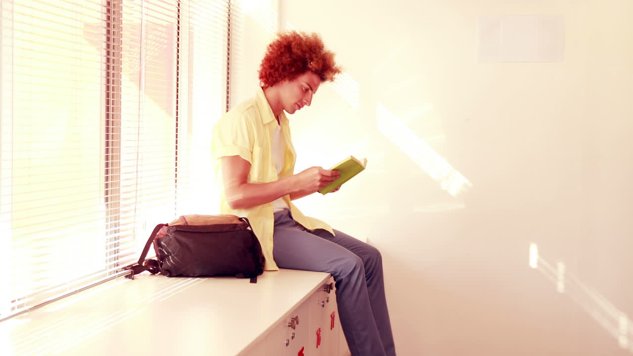 Happy student sitting on lockers 