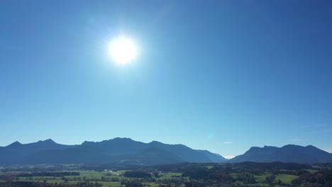 warm sunlight on the blue sky over austrian alps