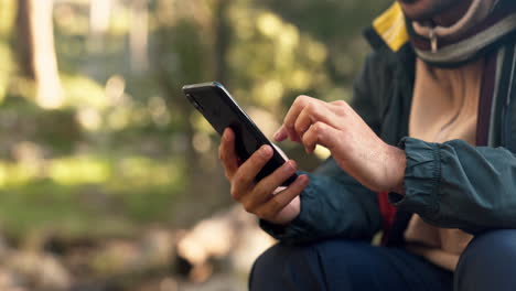 hands, phone and man hiking in a forest texting