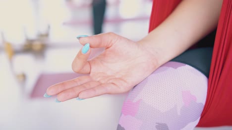 lady with manicure holds fingers in relaxing mudra position