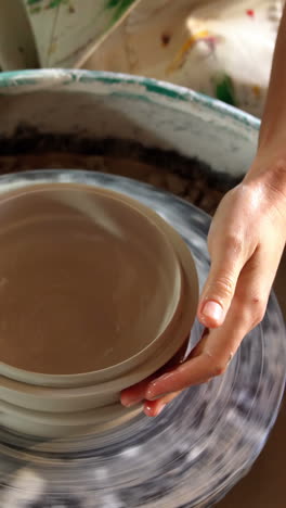 hands of female potter making a pot