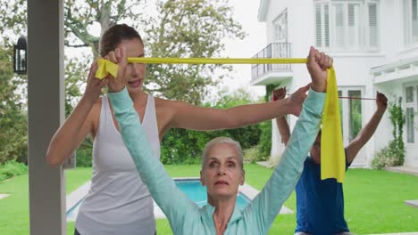 senior couple exercising in a garden