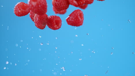 Row-of-raspberries-flying,-separating-in-air-after-being-launched