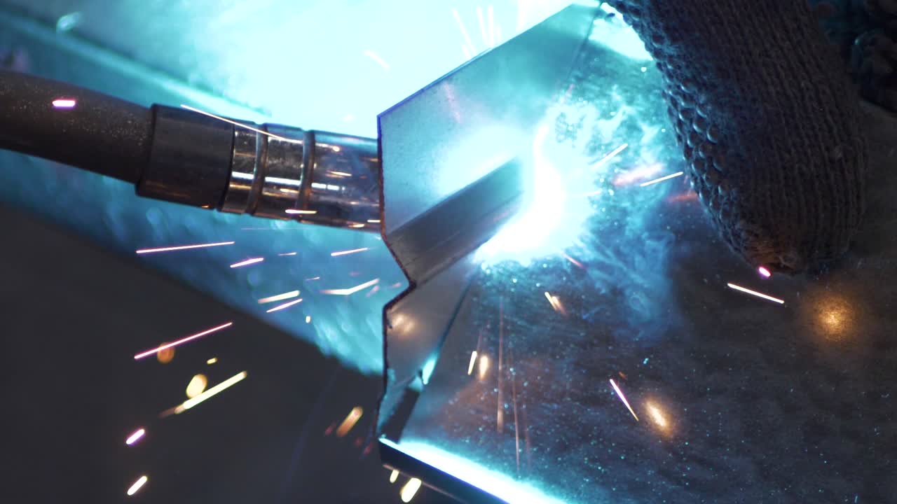 Welder works in metal construction - construction and processing of steel components