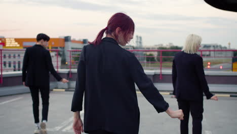 Girl-band-in-black-outfit-dancing-on-top-of-building