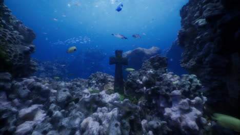underwater view of a cross structure amidst vibrant coral reef