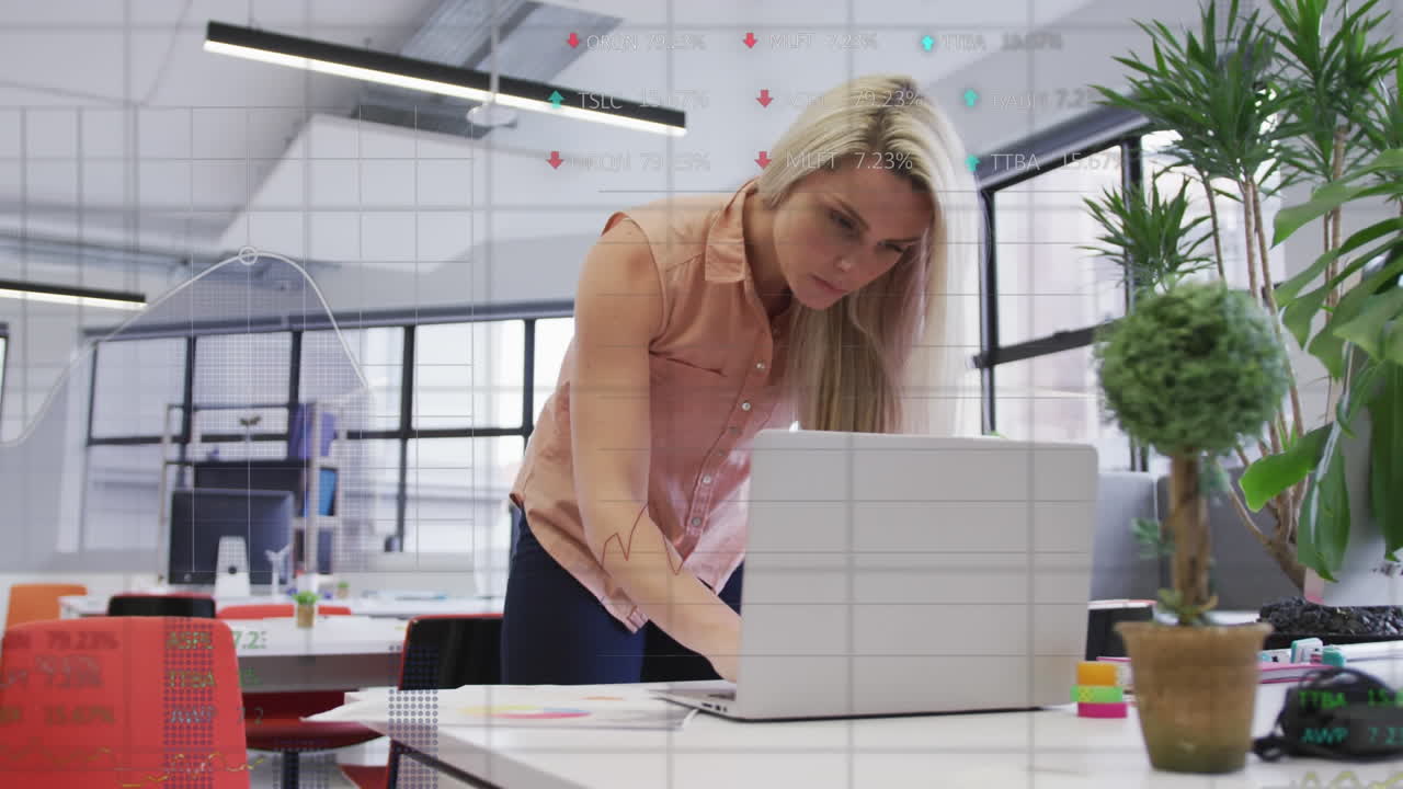 Animation of data processing over caucasian businesswoman using laptop