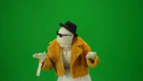 glamorous mummy in orange fur coat hat and sunglasses looks around looking for a victim and raising - glamorous mummy in orange fur coat, hat and sunglasses looks around looking for a victim and raising his hands. green screen isolated chroma key. mock up, workspace, advertisement. halloween holiday