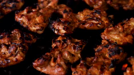 grilling chicken on a hot flaming grill - pull focus from blurry to sharp while zooming in