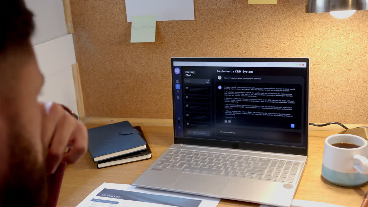 Working from home, man using laptop for online AI chatbot and project planning