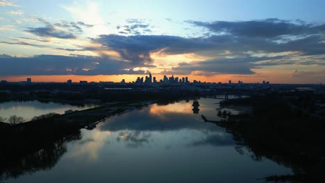 Panoramic-shot-of-the-Vistula-River-and-the-skyline-of-modern-Warsaw-from-a-rising-drone