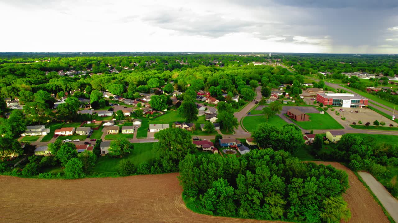 Davenport, Iowa, capturing a residential area and greenery with an approaching rainstorm in the distance