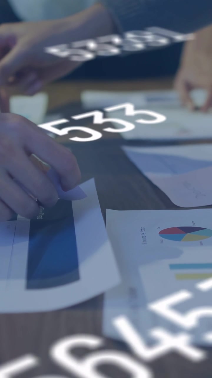 Vertical video: Team peeling note aligning bar numbers shifting dimming settling docs for finance