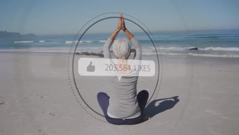 Animation-of-speech-bubble-with-thumbs-up-icon-and-numbers-over-woman-practicing-yoga-on-beach
